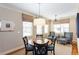 Cozy breakfast nook features a round granite table, four chairs, and natural light from multiple windows at 950 Brook Knoll Ln, Cumming, GA 30041