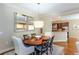 Elegant dining room featuring a round table, decorative mirrors, and a smooth transition to the open kitchen area at 950 Brook Knoll Ln, Cumming, GA 30041