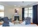 Comfortable living space featuring a fireplace, stylish armchairs, hardwood floors, and an adjacent window with natural light at 950 Brook Knoll Ln, Cumming, GA 30041