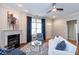 Relaxing living room showcasing a fireplace, sophisticated decor, hardwood floors, and a view of the home's entry at 950 Brook Knoll Ln, Cumming, GA 30041