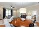 Open living room features hardwood floors, neutral walls, a ceiling fan, and a white sofa with dark blue pillows at 950 Brook Knoll Ln, Cumming, GA 30041