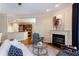 Cozy living room with a fireplace, plush seating, and an open layout flowing into the kitchen for easy entertaining at 950 Brook Knoll Ln, Cumming, GA 30041