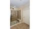 Modern tiled shower enclosure with a bench seat and glass door at 950 Brook Knoll Ln, Cumming, GA 30041