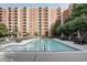 Large community pool with lounge chairs and umbrella-covered tables at the Mount Vernon Towers at 300 Johnson Ferry Rd # B614, Atlanta, GA 30328