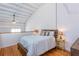 Bright loft bedroom with hardwood floors featuring sloped ceiling and a cozy queen-sized bed at 1661 La France Ne St # 216, Atlanta, GA 30307