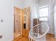 Stylish bedroom complete with a fun hanging chair and a view into the adjoining ensuite bath at 1661 La France Ne St # 216, Atlanta, GA 30307