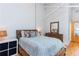 Cozy bedroom featuring a comfortable bed, wood floors, and high ceilings at 1661 La France Ne St # 216, Atlanta, GA 30307