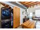 Open-concept living space featuring exposed ductwork, in-unit laundry, and views of the entry area with a cozy gray couch at 1661 La France Ne St # 216, Atlanta, GA 30307