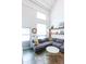 Bright living room with tall ceilings, large window, and cozy sectional at 1661 La France Ne St # 216, Atlanta, GA 30307