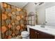 Bathroom with vanity, toilet, decorative shower curtain, and shelving unit at 2235 Emerald Springs Dr, Decatur, GA 30035