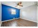 Bedroom featuring wood floors, a large window, and bright blue accent wall at 2235 Emerald Springs Dr, Decatur, GA 30035