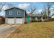 Charming home with a teal door, two-car garage and blue and grey accents at 2235 Emerald Springs Dr, Decatur, GA 30035
