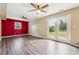 Open-plan living room with wood floors, a large window, and double doors to the back yard at 2235 Emerald Springs Dr, Decatur, GA 30035