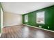 Bright living area featuring wood floors, neutral and emerald green walls and large windows at 2235 Emerald Springs Dr, Decatur, GA 30035