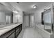 A neutral bathroom features granite counters, tile floor, a soaking tub, and a glass enclosed shower at 3608 Crayton Glen Way, Buford, GA 30519