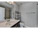 Modern bathroom featuring a vanity with chrome faucet, toilet, and tiled shower with glass doors at 3608 Crayton Glen Way, Buford, GA 30519