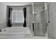Inviting bathroom features a soaking tub and separate glass-enclosed shower at 3608 Crayton Glen Way, Buford, GA 30519