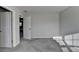 Bright bedroom featuring neutral walls, plush carpet, and a door with access to the bathroom at 3608 Crayton Glen Way, Buford, GA 30519