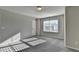 Bright bedroom featuring plush carpet, neutral paint, and a sun-filled window at 3608 Crayton Glen Way, Buford, GA 30519