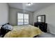 Comfortable bedroom with neutral walls, plush carpet, a dresser, and a bright window view at 3608 Crayton Glen Way, Buford, GA 30519