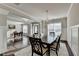 Dining area featuring a chandelier, wood floors, wainscoting, and a soft white rug at 3608 Crayton Glen Way, Buford, GA 30519