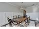 Dining area featuring a chandelier, wood floors, and wainscoting at 3608 Crayton Glen Way, Buford, GA 30519