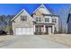 Charming two-story home featuring a combination of brick, stone, and siding, with an attached two-car garage at 3608 Crayton Glen Way, Buford, GA 30519