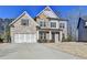 Charming two-story home featuring a combination of brick, stone, and siding, with an attached two-car garage at 3608 Crayton Glen Way, Buford, GA 30519