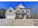 Charming two-story home featuring a combination of brick, stone, and siding, with an attached two-car garage at 3608 Crayton Glen Way, Buford, GA 30519