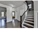 Foyer with hardwood floors, white walls, and a stairway with dark wood railing at 3608 Crayton Glen Way, Buford, GA 30519