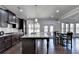 Modern kitchen features dark wood cabinetry, granite countertops, and stainless steel appliances at 3608 Crayton Glen Way, Buford, GA 30519
