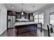 Eat-in kitchen features an island, stainless appliances, and lots of natural light at 3608 Crayton Glen Way, Buford, GA 30519