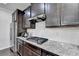 Well-equipped kitchen featuring granite counters, stainless steel appliances, and dark wood cabinets at 3608 Crayton Glen Way, Buford, GA 30519