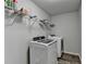 This functional laundry room is equipped with modern washer and dryer units, plus wire storage shelving at 3608 Crayton Glen Way, Buford, GA 30519