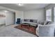Inviting living room featuring comfortable seating, elegant rug, and abundant natural light at 3608 Crayton Glen Way, Buford, GA 30519