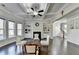 Bright living room filled with natural light and featuring a fireplace with built-in shelving and coffered ceilings at 3608 Crayton Glen Way, Buford, GA 30519