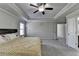 Spacious main bedroom featuring tray ceilings, ceiling fan, and neutral colors at 3608 Crayton Glen Way, Buford, GA 30519