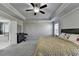 Bright main bedroom featuring en-suite bath, tray ceiling, and ceiling fan at 3608 Crayton Glen Way, Buford, GA 30519