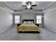 Spacious main bedroom features tray ceilings, ceiling fan, and large windows at 3608 Crayton Glen Way, Buford, GA 30519