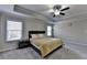 Comfortable main bedroom with ceiling fan, side table, and large window at 3608 Crayton Glen Way, Buford, GA 30519