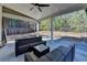 A covered patio offering ample seating and an outdoor ceiling fan, with a view of the wooded backyard at 3608 Crayton Glen Way, Buford, GA 30519