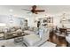 Open-concept living room with a sectional sofa, ceiling fan, and view into the kitchen and breakfast area at 1238 Weatherstone Ne Dr, Atlanta, GA 30324