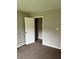 This bedroom features neutral walls, carpet, closet, and an electrical outlet at 304 Deerfield Dr, Jonesboro, GA 30238