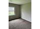 This bedroom features a window with a view of the outdoors and carpet at 304 Deerfield Dr, Jonesboro, GA 30238