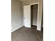 This bedroom features neutral walls, carpet, closet, and an electrical outlet at 304 Deerfield Dr, Jonesboro, GA 30238