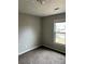This bedroom features a window with a view of the outdoors and carpet at 304 Deerfield Dr, Jonesboro, GA 30238