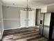 This dining room features laminate flooring, a stainless refrigerator and plenty of space at 304 Deerfield Dr, Jonesboro, GA 30238