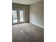 View of the living room with carpet and access to back yard at 304 Deerfield Dr, Jonesboro, GA 30238