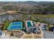 Stunning aerial view showcasing a pool, tennis court, and lake at 4205 Madison Hall Dr, Cumming, GA 30028