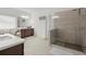 Modern bathroom featuring a glass shower, tiled floors, and dual sinks at 4205 Madison Hall Dr, Cumming, GA 30028